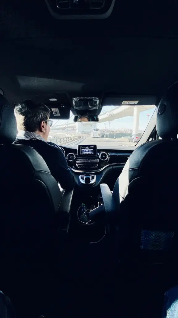 Rhodes chauffeur in a suit driving a private Mercedes